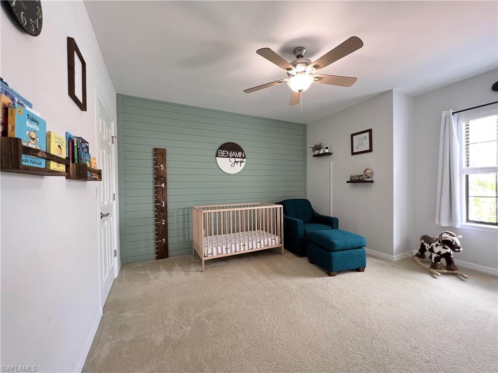 14776 Sutherland Avenue, Unit 416 Naples, FL 34119 - Photo 34 of 50 a bedroom with a bed and a ceiling fan
