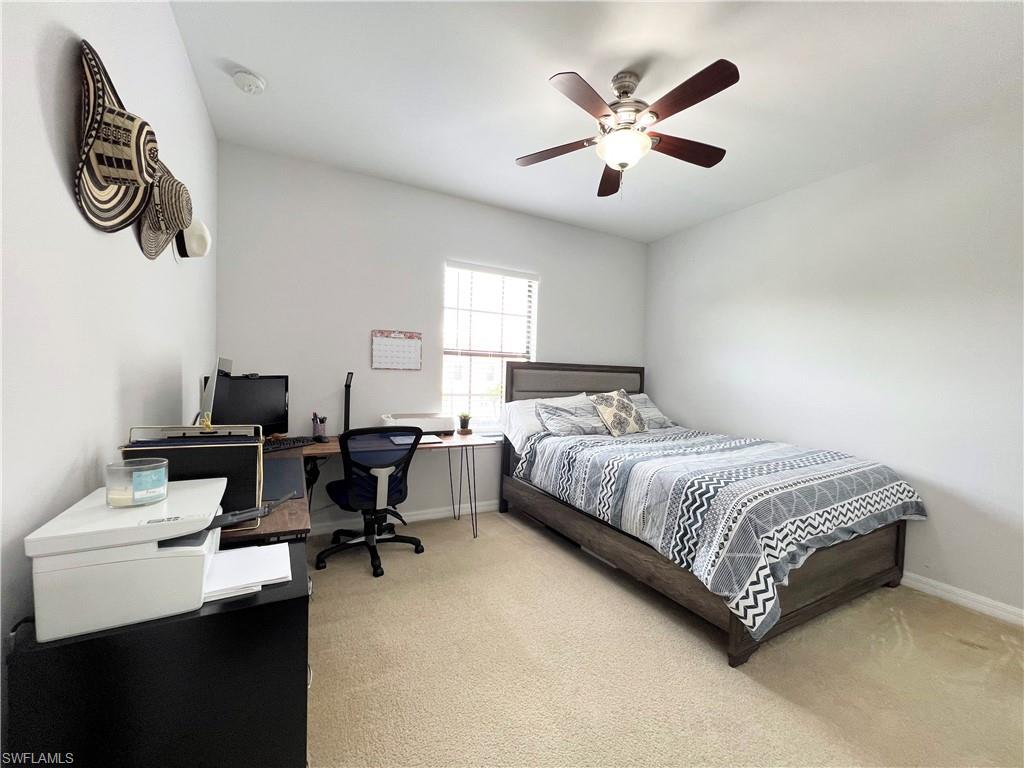 14776 Sutherland Avenue, Unit 416 Naples, FL 34119 - Photo 39 of 50 a bedroom with a bed and a chandelier