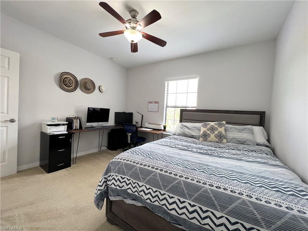14776 Sutherland Avenue, Unit 416 Naples, FL 34119 - Photo 40 of 50 a bedroom with a bed and a chandelier