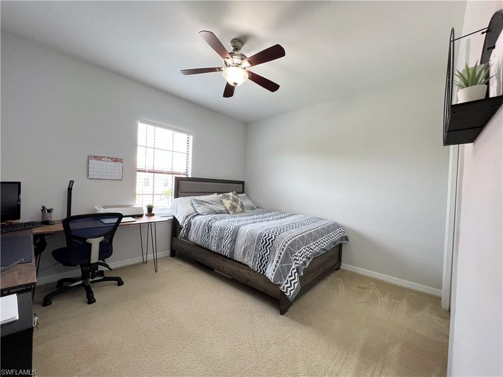 14776 Sutherland Avenue, Unit 416 Naples, FL 34119 - Photo 41 of 50 a bedroom with a bed and a desk