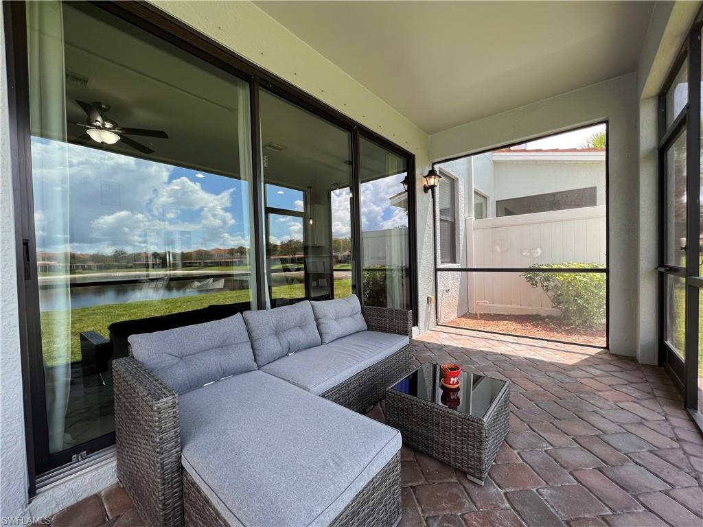 14776 Sutherland Avenue, Unit 416 Naples, FL 34119 - Photo 47 of 50 a living room with furniture and a floor to ceiling window
