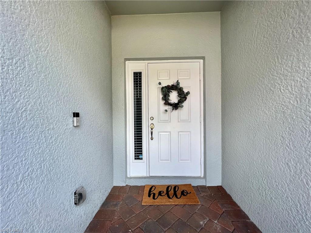 14776 Sutherland Avenue, Unit 416 Naples, FL 34119 - Photo 6 of 50 a room with a door and couch