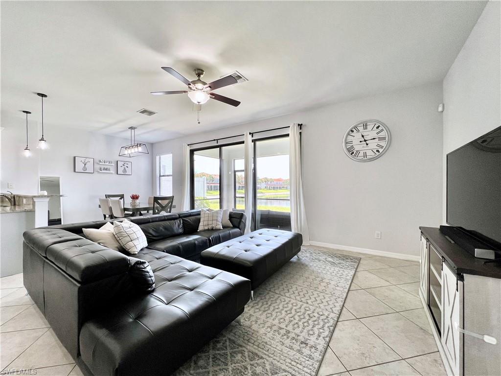 14776 Sutherland Avenue, Unit 416 Naples, FL 34119 - Photo 9 of 50 a living room with couches a fireplace and a flat screen tv