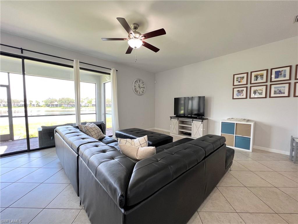 14776 Sutherland Avenue, Unit 416 Naples, FL 34119 - Photo 10 of 50 a living room with furniture and a large window