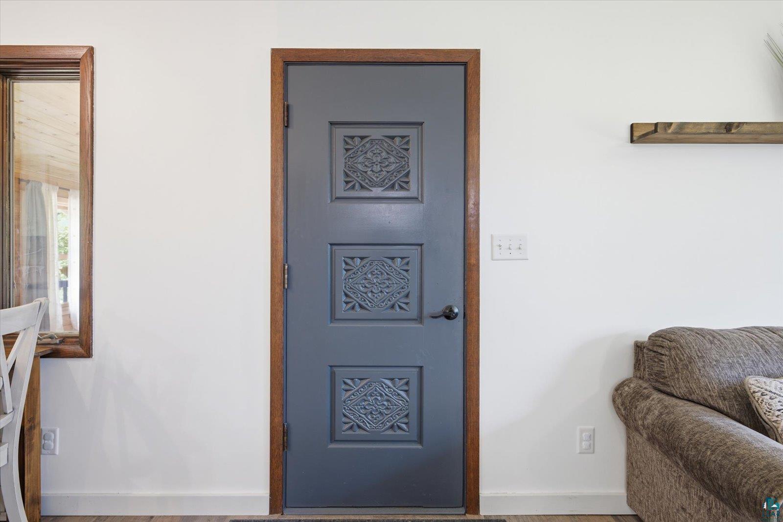 6377 Bergstrom Road Saginaw, MN 55779 - Photo 11 of 20 Interior door with decorative panels, dark hardware, and a wood-finish frame