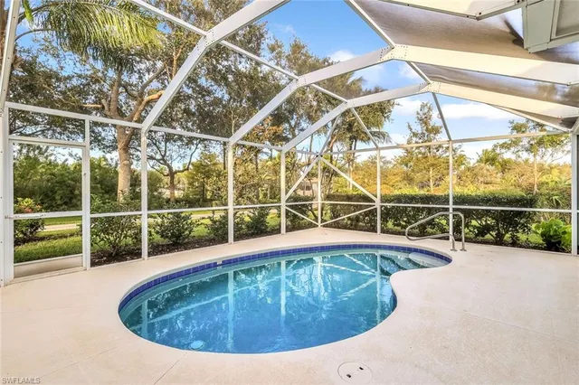 a view of a swimming pool with a couches in a patio