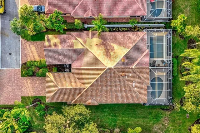 an aerial view of residential houses with outdoor space and lake view