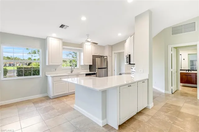 a kitchen with stainless steel appliances granite countertop a sink and a stove
