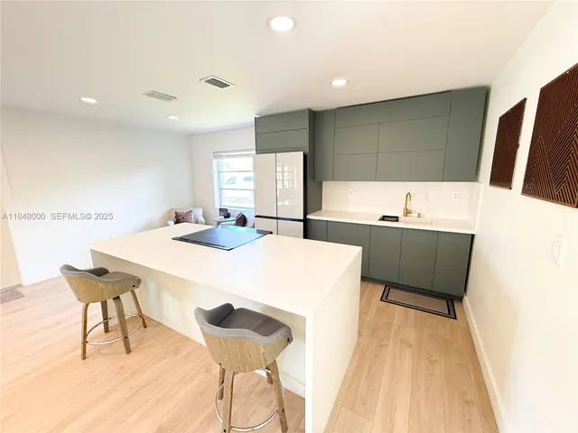 a kitchen with a table chairs and a refrigerator