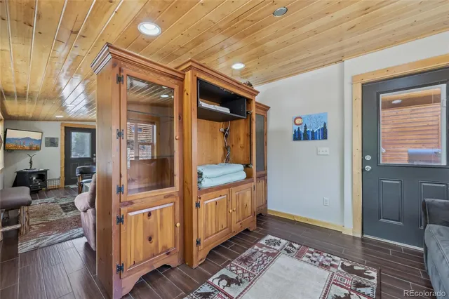 a kitchen with stainless steel appliances granite countertop a refrigerator a stove a sink a microwave and a refrigerator