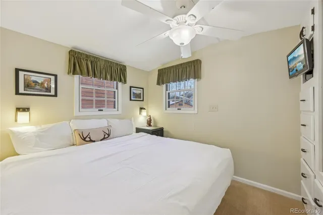 a view of a house with a swimming pool and sitting area