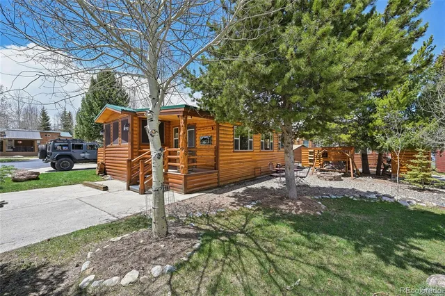 a living room with furniture a flat screen tv and a large window