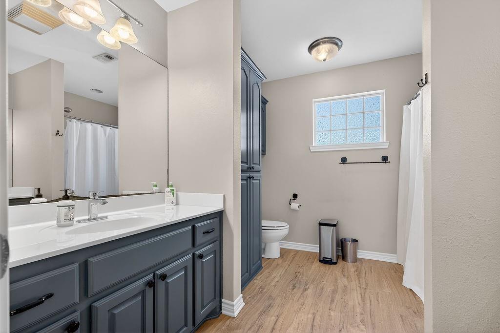 7811 Double Oaks Road Athens, TX 75752 - Photo 33 of 38 a bathroom with a sink and a mirror