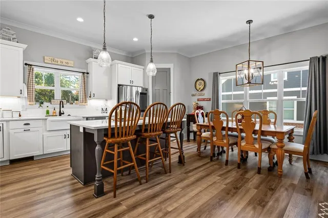 a very nice looking dining room with kitchen island hardwood floor and a view of living room