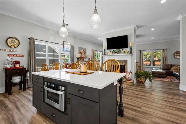 a view of a dining room with furniture wooden floor and chandelier