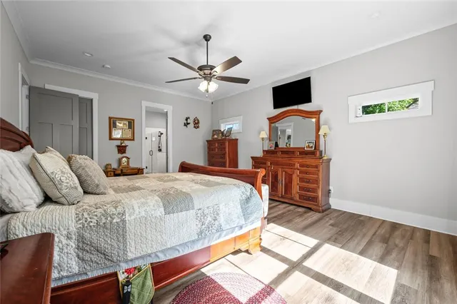 a bed room with a bed mirror dresser and a window
