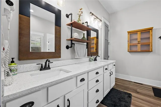 a bathroom with a double vanity sink and a mirror
