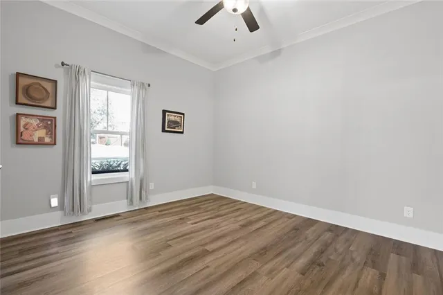 wooden floor in an empty room with a window