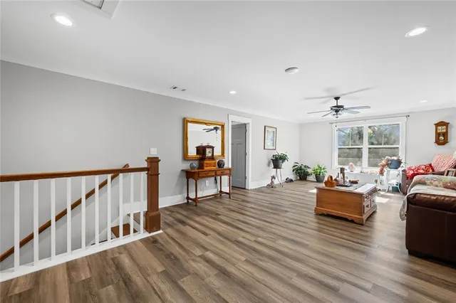 a living room with furniture and a wooden floor