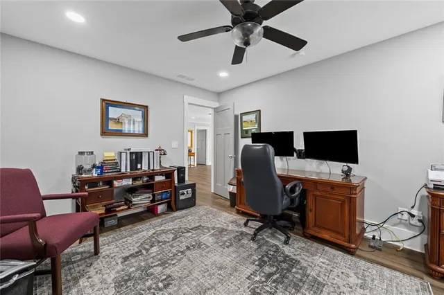 a view of a livingroom with workspace and a window