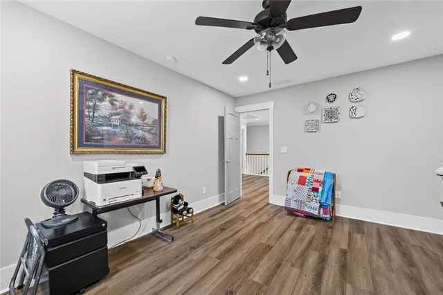 a bedroom with furniture and wooden floor