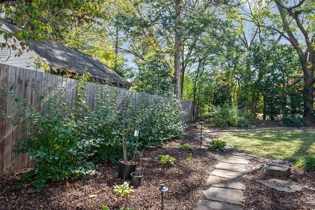 a view of a backyard with large trees