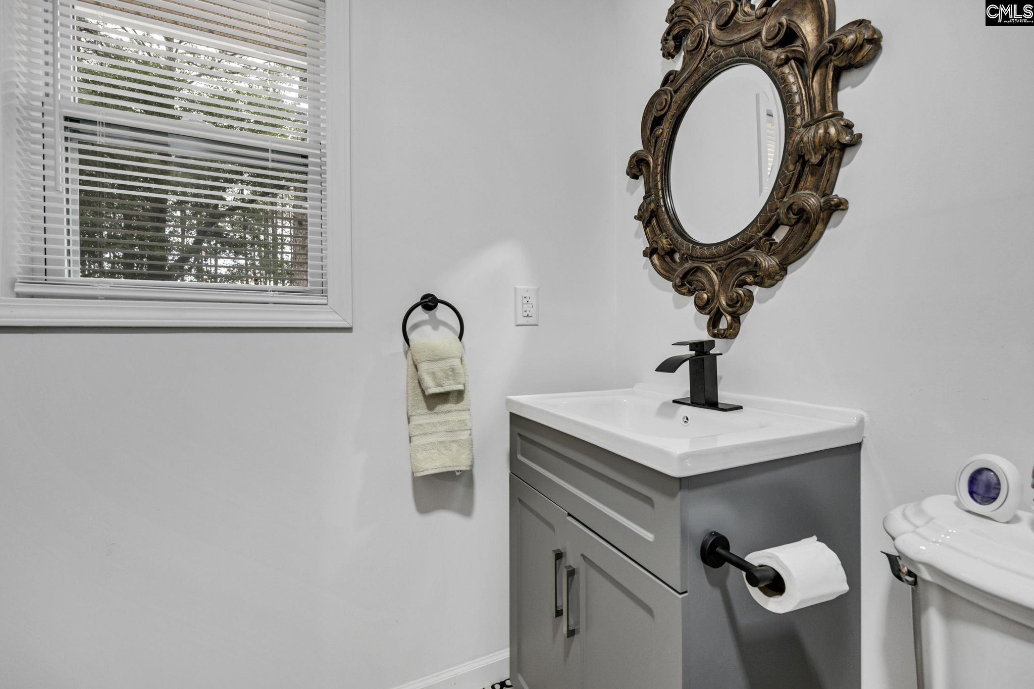 8107 Black River Road Rembert, SC 29128 - Photo 22 of 38 a bathroom with a sink and a mirror