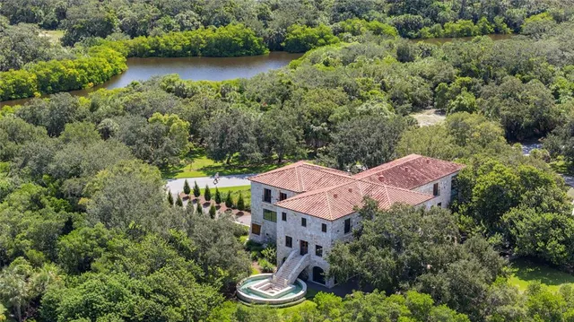 an aerial view of house with yard and outdoor seating