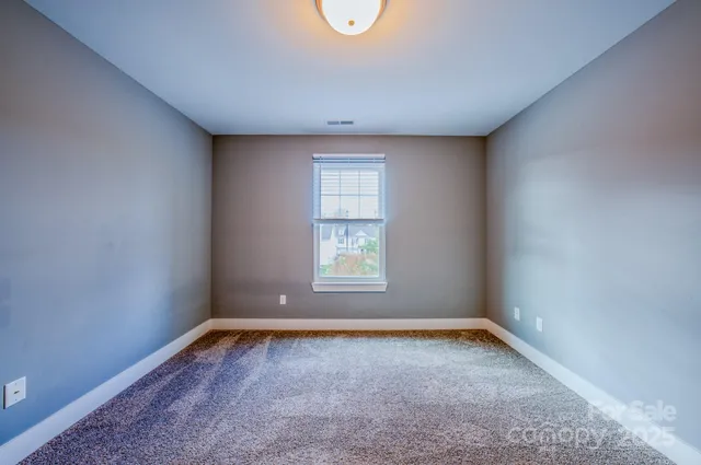 a bathroom with a granite countertop sink mirror vanity and toilet