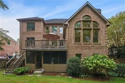 a view of a brick house with a yard