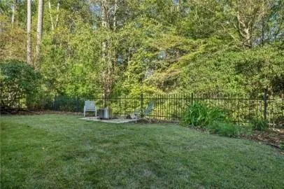 a view of a big yard with large trees