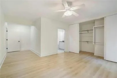 a view of an empty room with a ceiling fan