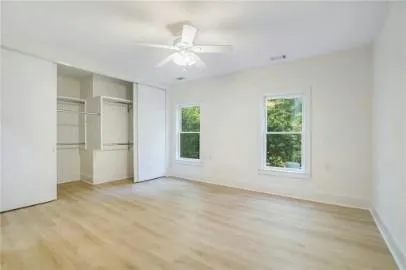 an empty room with windows and closet