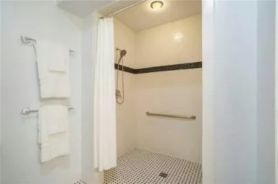 a bathroom with a shower and a glass door