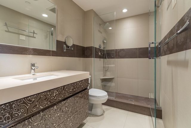 a bathroom with a sink a toilet and a shower