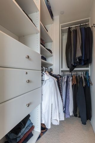 a view of walk in closet with clothes and shoes