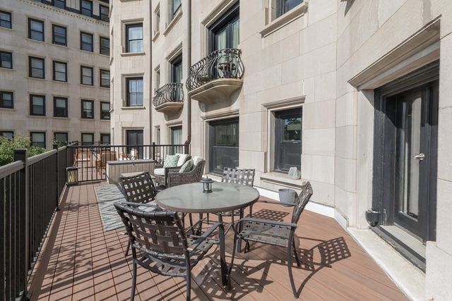a view of a patio with a table and chairs