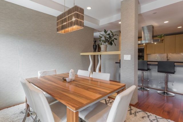 a dining table with chairs and wooden floor