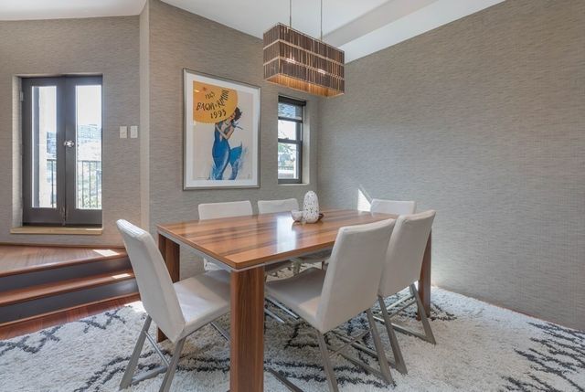 a view of a dining room with furniture and window