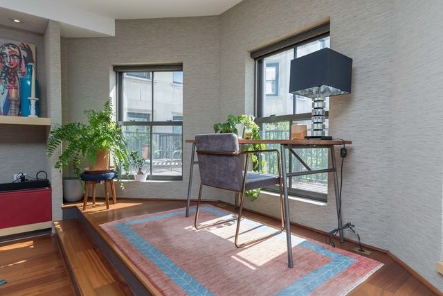 a living room with furniture and a potted plant