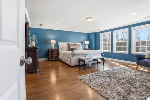 a living room with furniture rug and wooden floor
