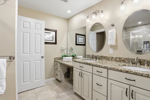 a bathroom with a double vanity sink and a mirror