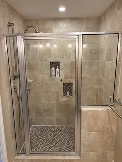 a bathroom with a glass shower door