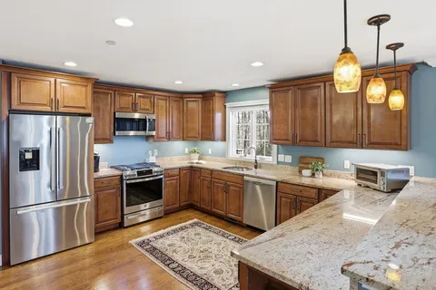 a kitchen with a refrigerator sink and stove