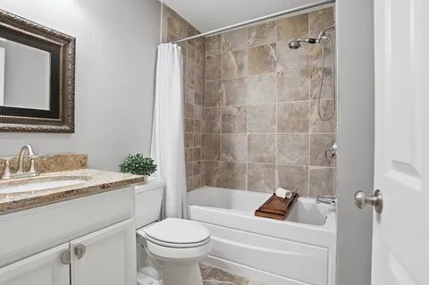 a bathroom with a sink toilet a mirror and shower