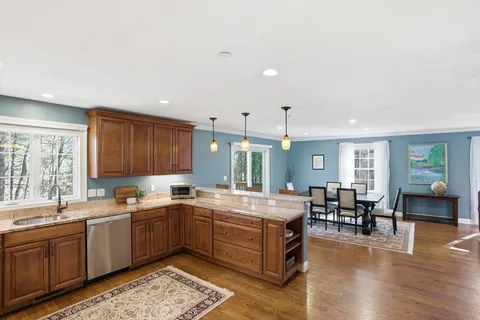 a kitchen with a sink window and cabinets