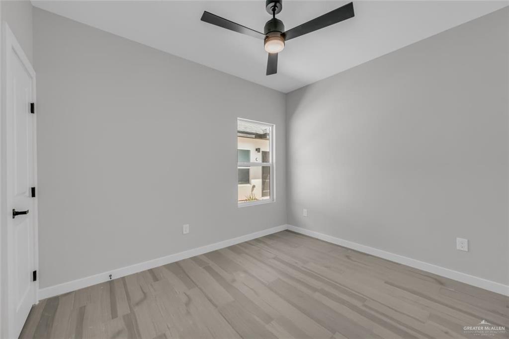 11509 North 25th Street, Unit A McAllen, TX 78504 - Photo 12 of 17 Spare room with light wood finished floors and ceiling fan
