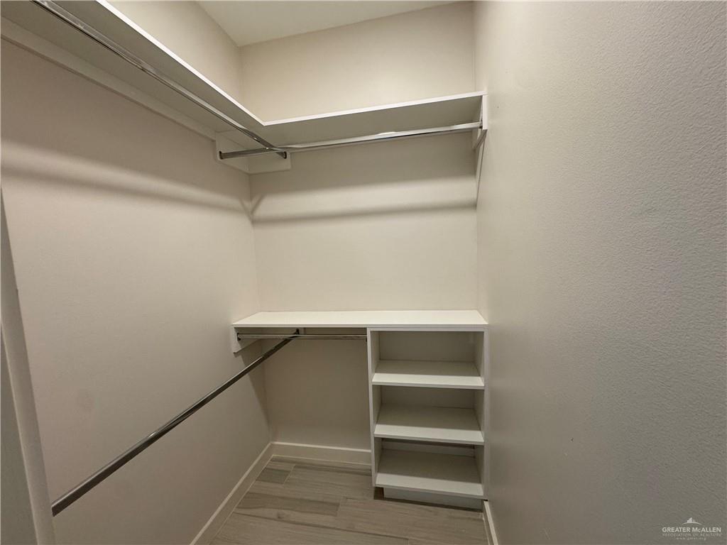 11509 North 25th Street, Unit A McAllen, TX 78504 - Photo 14 of 17 Spacious closet featuring light wood finished floors