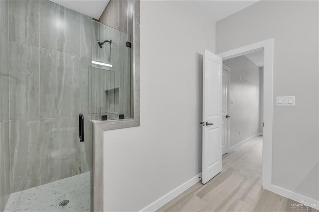 11509 North 25th Street, Unit A McAllen, TX 78504 - Photo 15 of 17 Full bathroom featuring a stall shower and light wood-type flooring