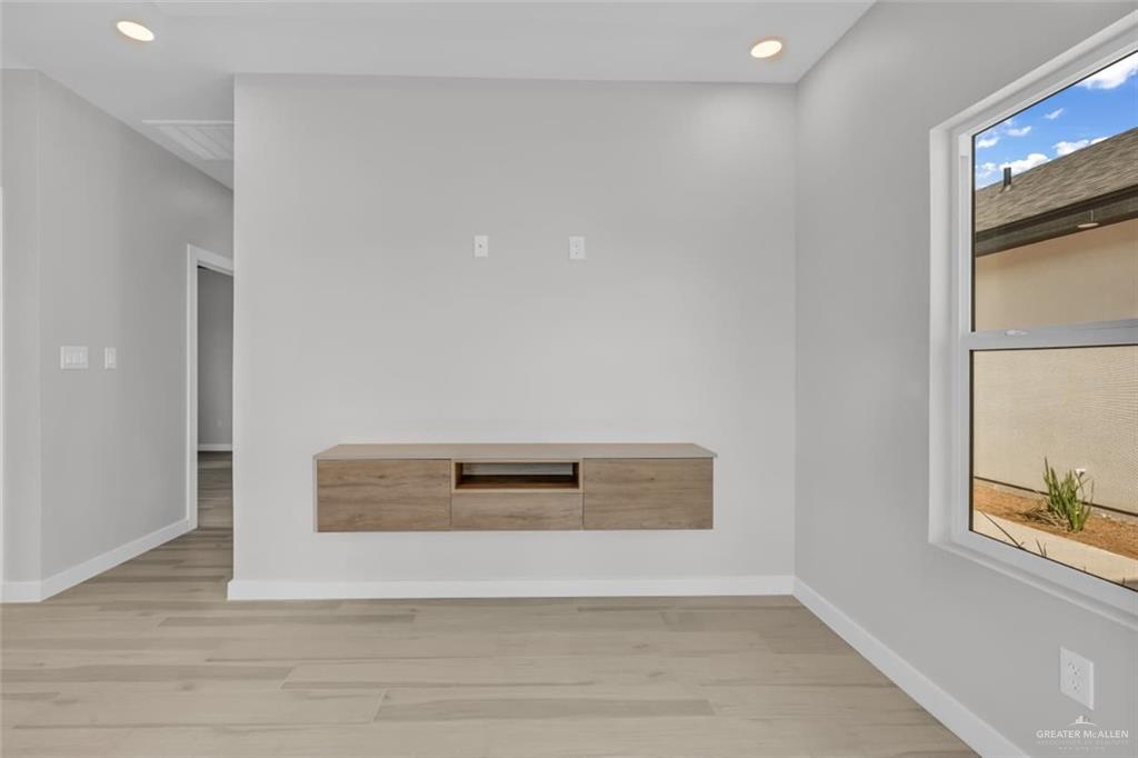 11509 North 25th Street, Unit A McAllen, TX 78504 - Photo 6 of 17 Unfurnished room with wood finished floors and recessed lighting